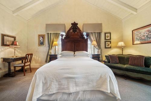 a bedroom with a large bed and a couch at Brinnwood Bed & Breakfast in Sutter Creek