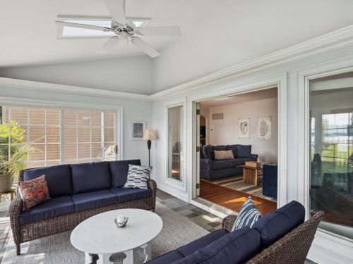 a living room with blue couches and a table at Miles Rest in Royal Oak