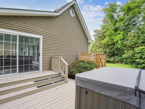 a backyard deck with a grill and a house at Miles Rest in Royal Oak