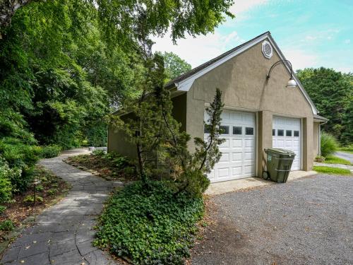 a house with two garage doors and a driveway at Miles Rest in Royal Oak