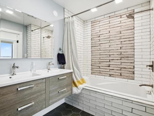 a bathroom with a tub and a sink and a shower at Mill Point in Neavitt