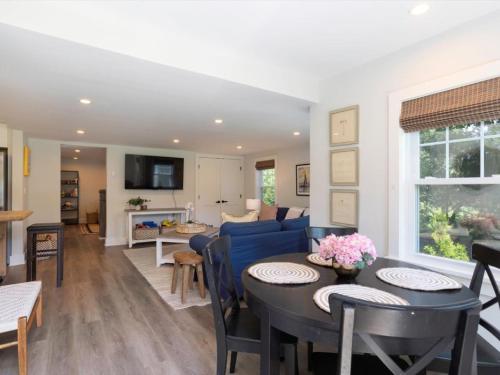 a living room with a blue couch and a table at The Weekender in Mount Pleasant