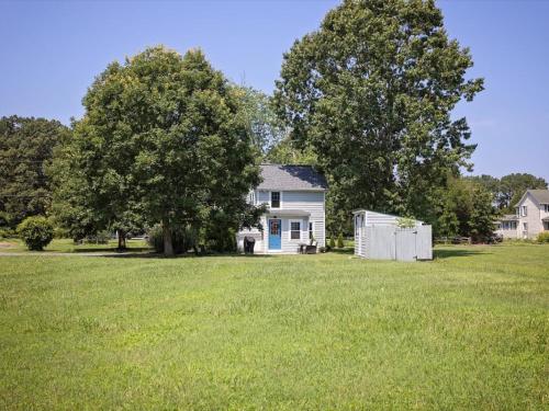a white house with a tree and a yard at The Weekender in Mount Pleasant