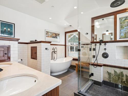 a bathroom with a tub and a shower and a sink at The Water House in Saint Michaels