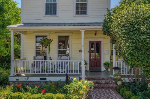 a yellow house with a front porch with a red door at Brinnwood Bed & Breakfast in Sutter Creek