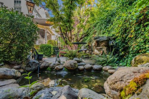 a pond in front of a house with a garden at Brinnwood Bed & Breakfast in Sutter Creek