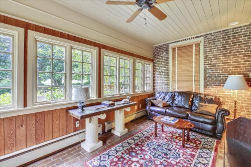 a living room with a leather couch and a table at Thornton in Kennedyville