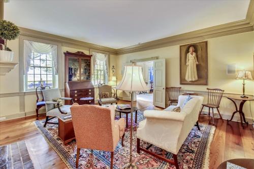a living room with chairs and a table at Thornton in Kennedyville