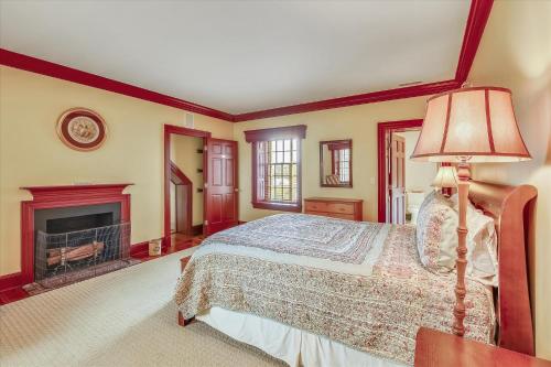 a bedroom with a bed and a fireplace at Thornton in Kennedyville