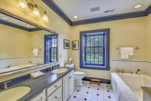 a bathroom with two sinks and a tub and a toilet at Thornton in Kennedyville