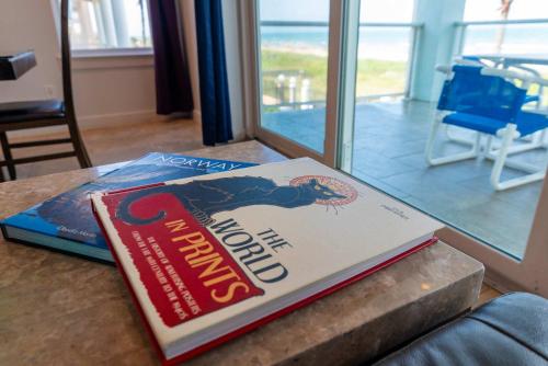 a book sitting on top of a table at 5 BEDROOM BEACHFRONT CONDO - 2nd Floor in South Padre Island