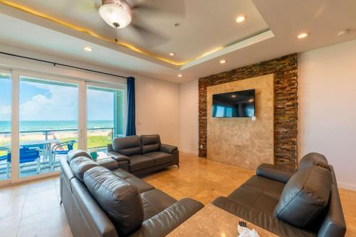 a living room with a couch and two chairs at 5 BEDROOM BEACHFRONT CONDO - 2nd Floor in South Padre Island