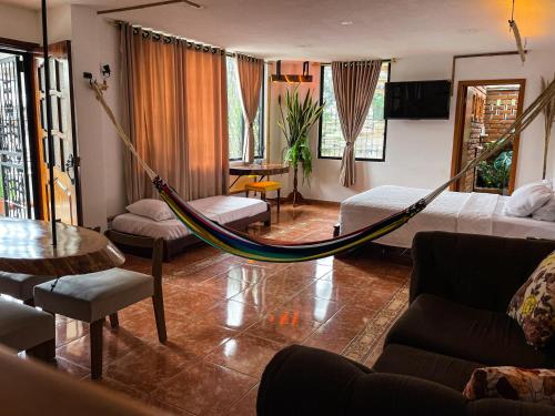 una sala de estar con una hamaca en una habitación en Raíces y Refugio, en Puyo