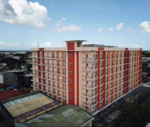 a tall building with a red in a city at Riverside 2 Bedroom 5 Beds in Naga