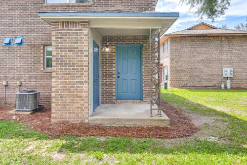 a blue door on a brick house with a yard at 2 Mi to State Park Dog-Friendly Niceville Home in Niceville