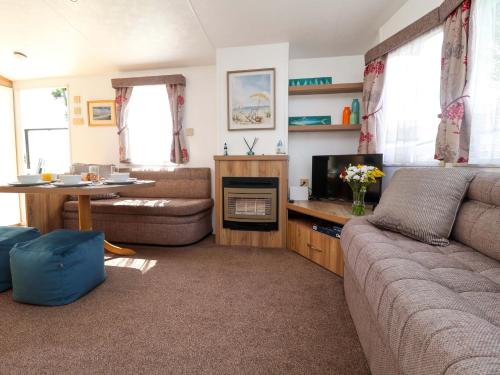 a living room with a couch and a table at 21 Poplar Avenue in Felixstowe