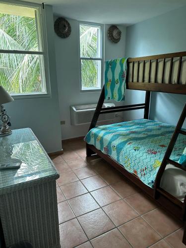 a bedroom with a bunk bed and a table at Beach Front Penthouse in Loiza