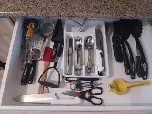 a tray filled with utensils and other kitchen utensils at Beach Front Penthouse in Loiza