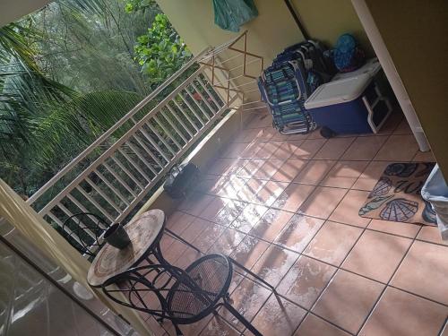 an empty chair in a room with a staircase at Beach Front Penthouse in Loiza
