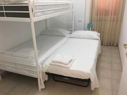 a bedroom with two bunk beds in a room at Case sul mare in Palau