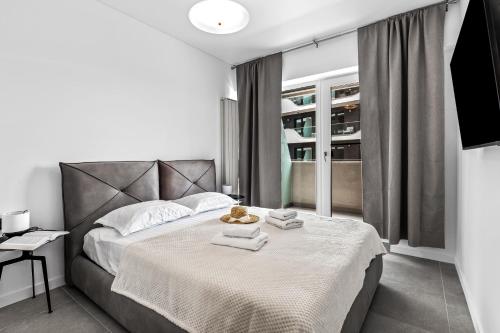 a bedroom with a bed with towels on it at SIA in Odyssey Pool & Spa Resort in Năvodari