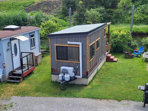 a small house sitting on top of a grass field at Tiny Home By The Beach in Blaine