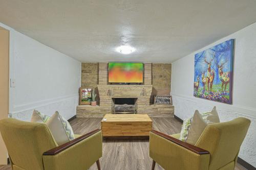 a living room with two chairs and a fireplace at Communal Crashpad-City Card for local biz discounts in Oklahoma City