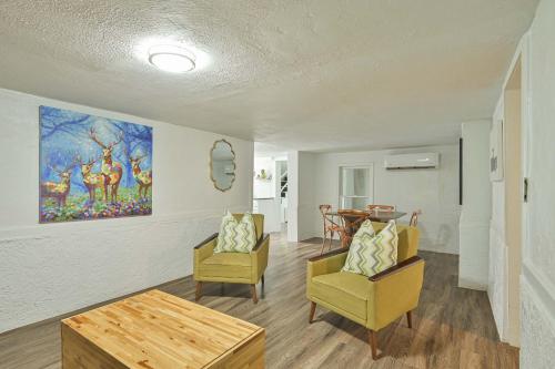 a living room with two chairs and a painting on the wall at Communal Crashpad-City Card for local biz discounts in Oklahoma City