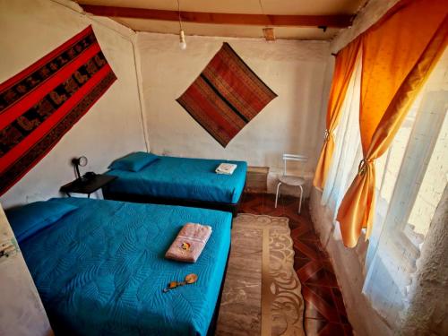 a room with two beds in a tent at CASA HOSTAL LA PASKANA ATACAMEÑa in San Pedro de Atacama