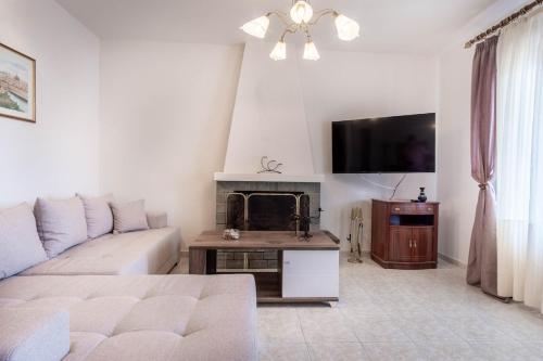 a living room with a couch and a fireplace at Kallisti's house in Mákri