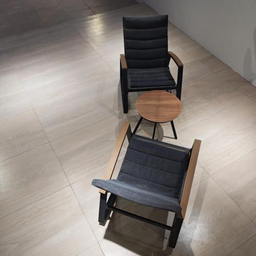two chairs and a table on a tile floor at لآلي شاليه Laali Chalet in Birkat al Mawz