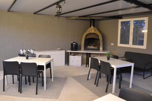 a room with two tables and chairs and a kitchen at Mas Solana in Huércal-Overa