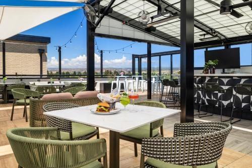a dining room with a white table and chairs at Hotel Katerina in Chico