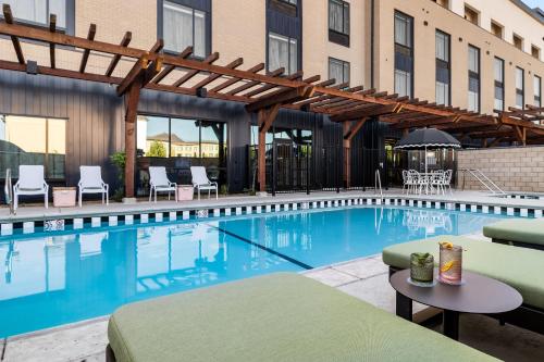 a pool at a hotel with chairs and a table at Hotel Katerina in Chico