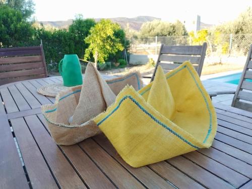two baskets sitting on top of a wooden table at Villa Elaida in Ermioni