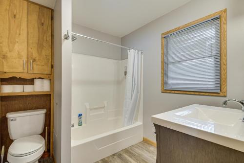 a bathroom with a toilet and a shower and a sink at Scenic Views and Yard Mississippi River Retreat! in Fulton