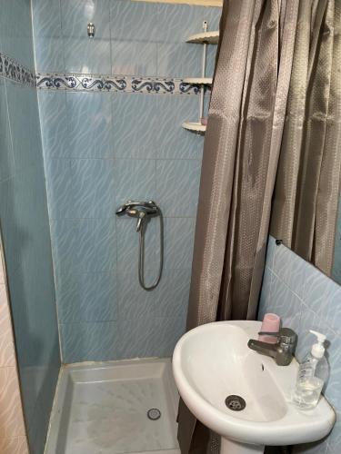 a small bathroom with a sink and a shower at Sunny City Villa with a Garden in Erfoud