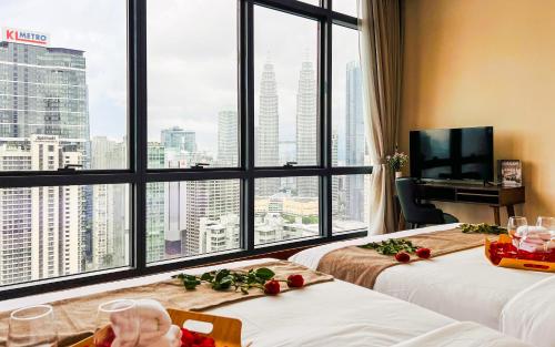 a hotel room with two beds and a large window at TM Persiaran Stonor KLCC - MK HOME in Kuala Lumpur