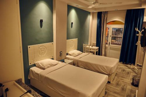 a hospital room with two beds and a mirror at Town Hotel- Hurghada in Hurghada
