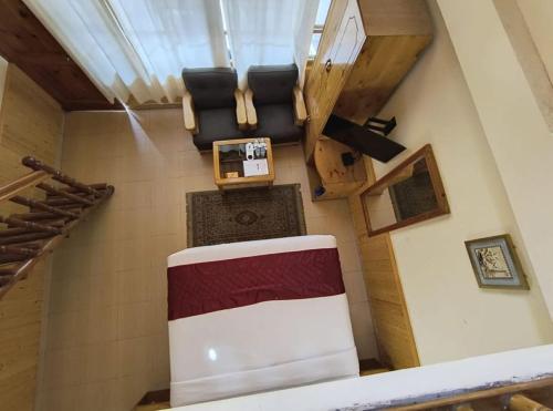 an overhead view of a living room with a table and chairs at Hotel Purnima Kasol in Kasol