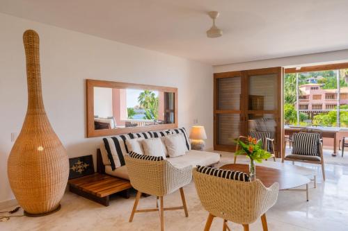 a living room with a couch and a table at El Careyes Club & Residences in Careyes