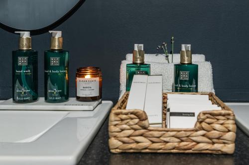 a table with three bottles of essential oils and a basket at Number 59 Dublin in Dublin