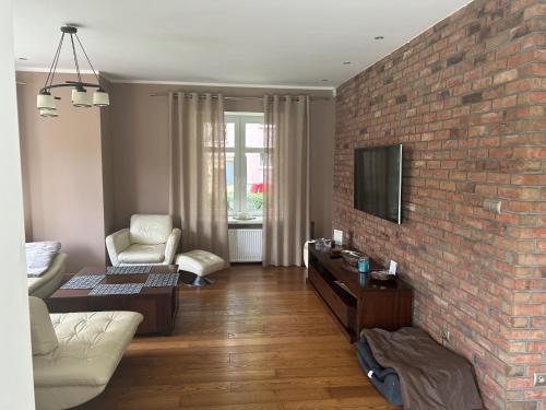 a living room with a brick wall at Narutowicza 71-1 in Inowrocław