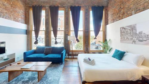 a room with a bed and a couch and a table at The Lofts at 107 in Nashville