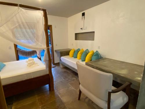 a room with two beds and a table and a chair at casanossa prea in Prea