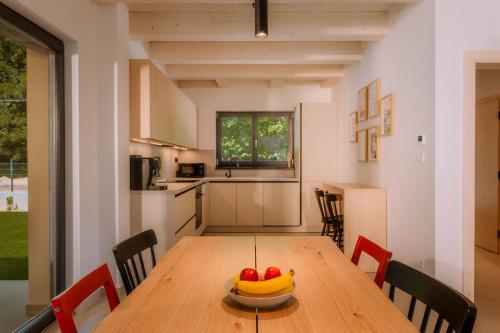 a kitchen with a wooden table with a bowl of fruit on it at BINDT chalets in Hnilčík