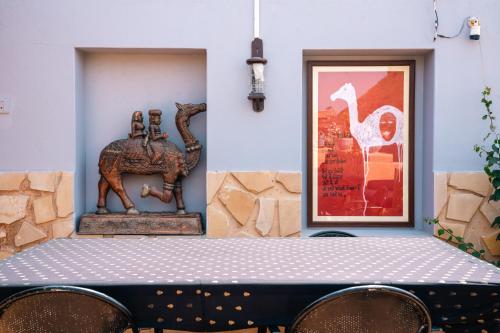 a table with a statue of a horse and a picture at Jaisalmer Elite Castle in Jaisalmer