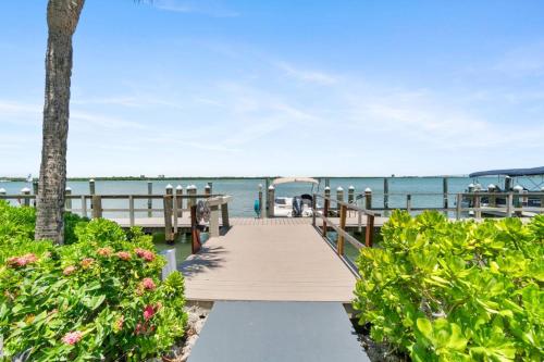 a wooden boardwalk leading to the beach at Riverside Club A209 in Marco Island