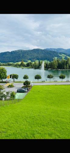 a large body of water with a fountain in the background at 1 room apartment in Canton Zug in Unterägeri