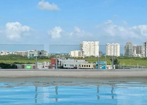 a body of water with a city in the background at Leu boutique condos in Cancún